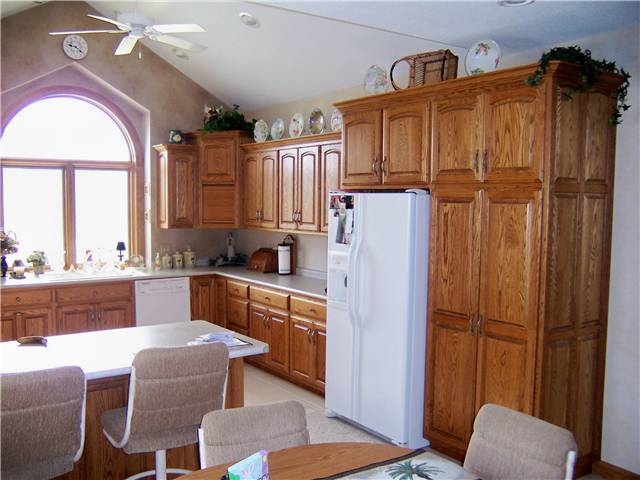 Red oak cabinets - Raised panel doors and side panels - Standard overlay style - Laminate countertops